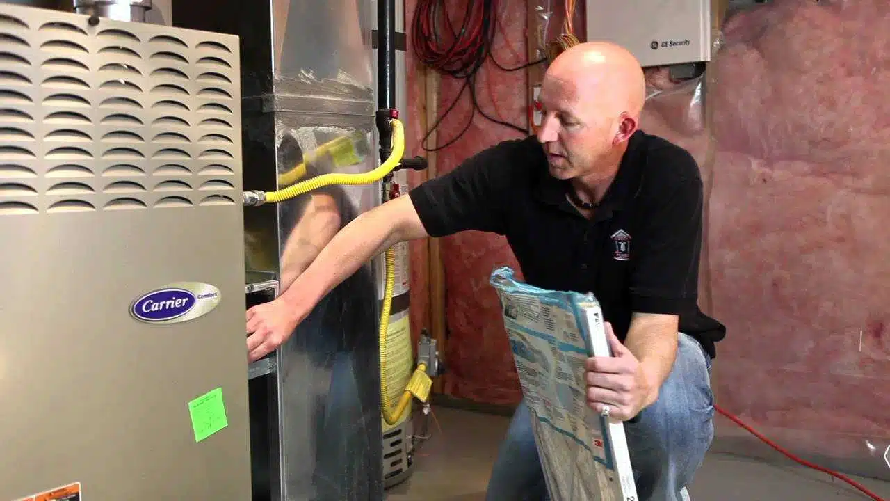 technician doing furnace filter changing