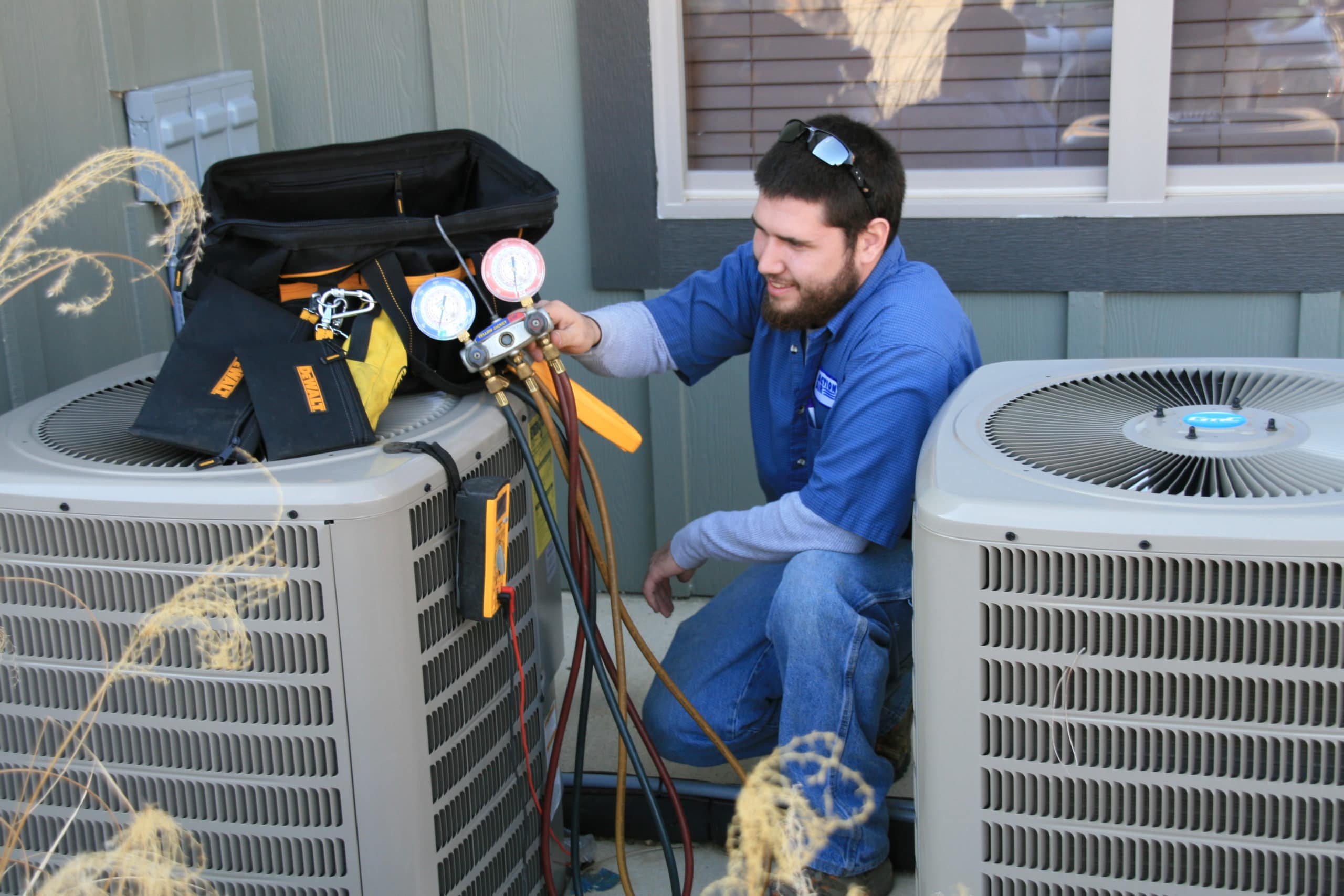 technician performing an air conditioner tune up