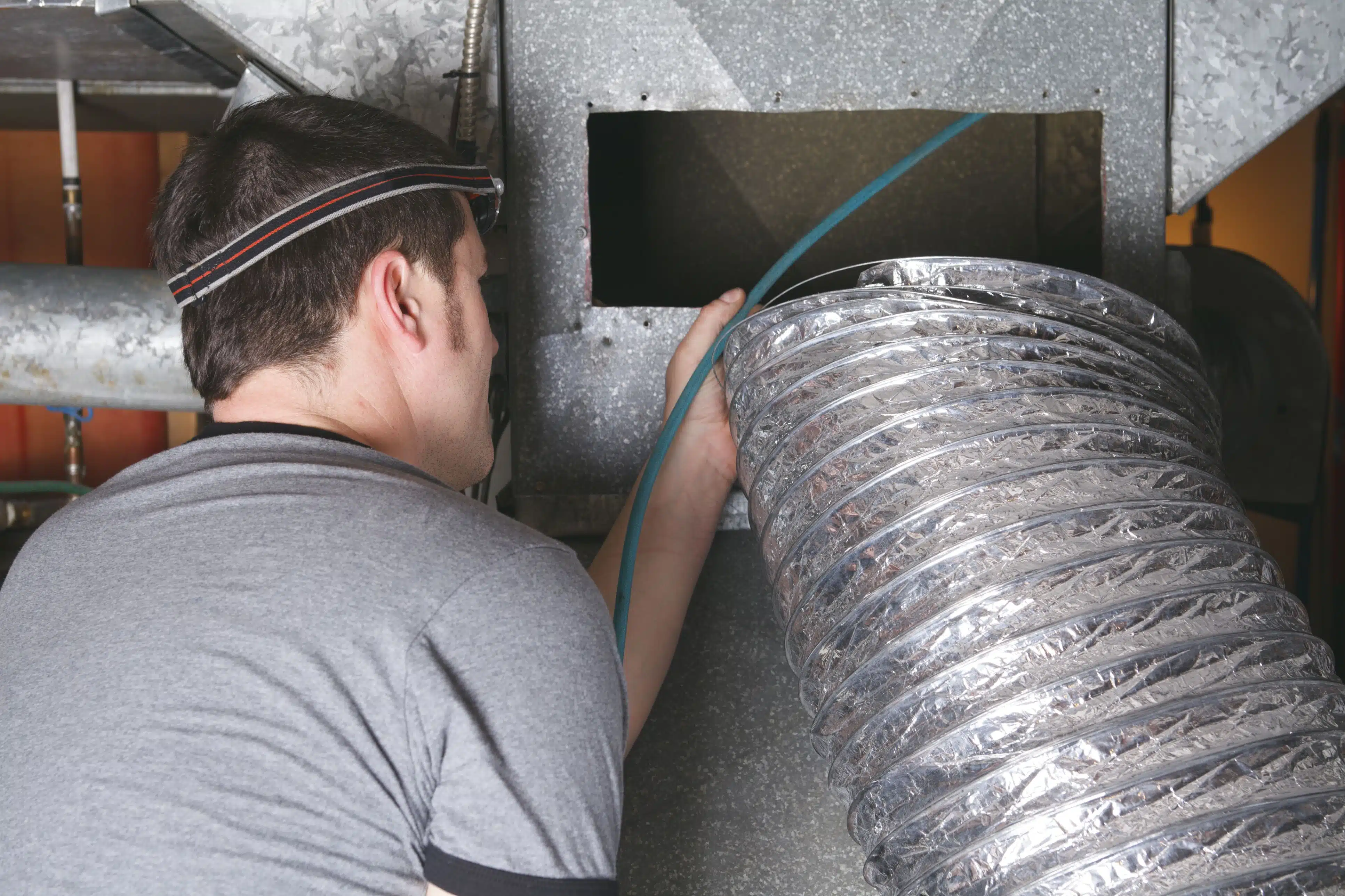 technician performs furnace duct cleaning