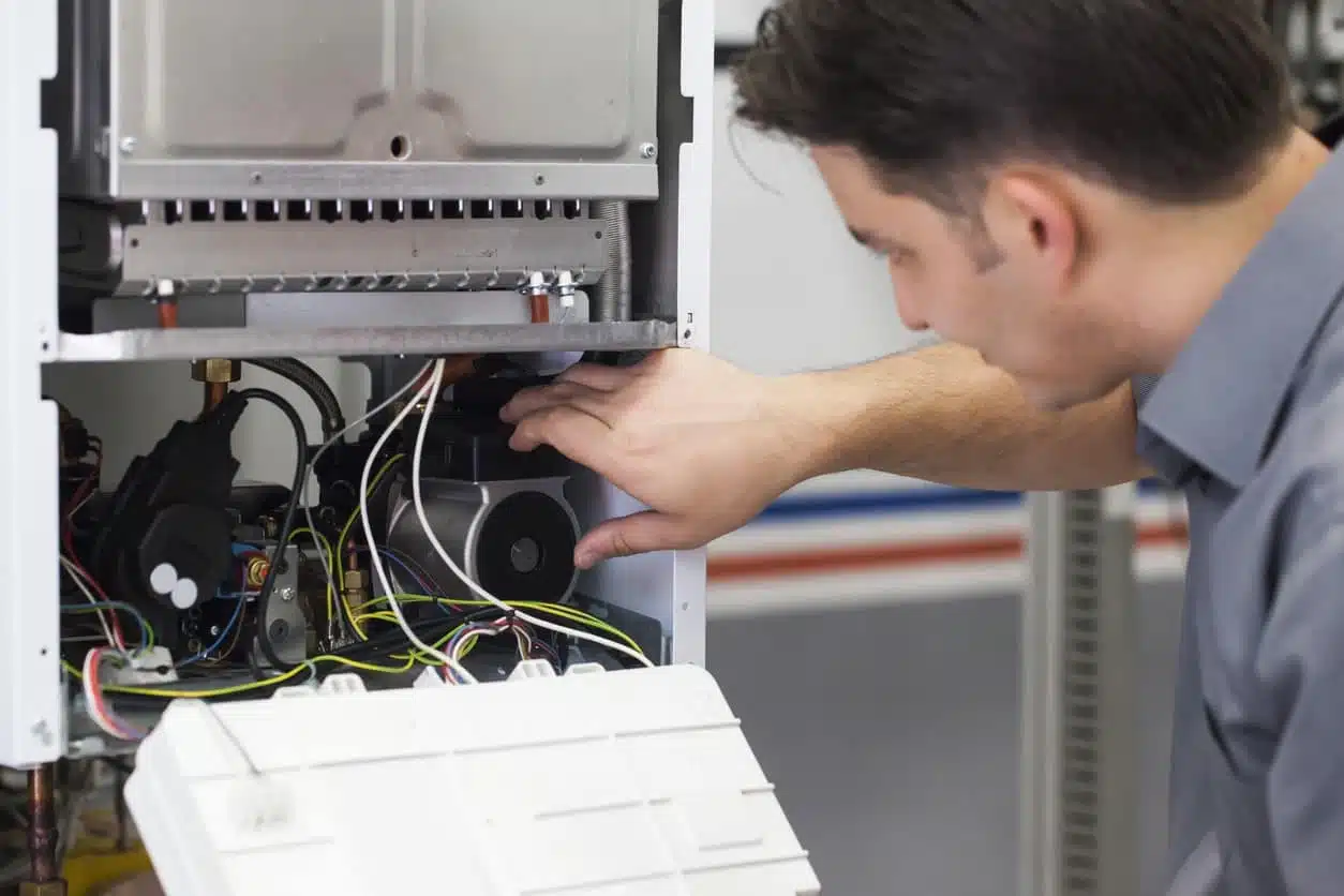 technician troubleshooting a furnace that stops working